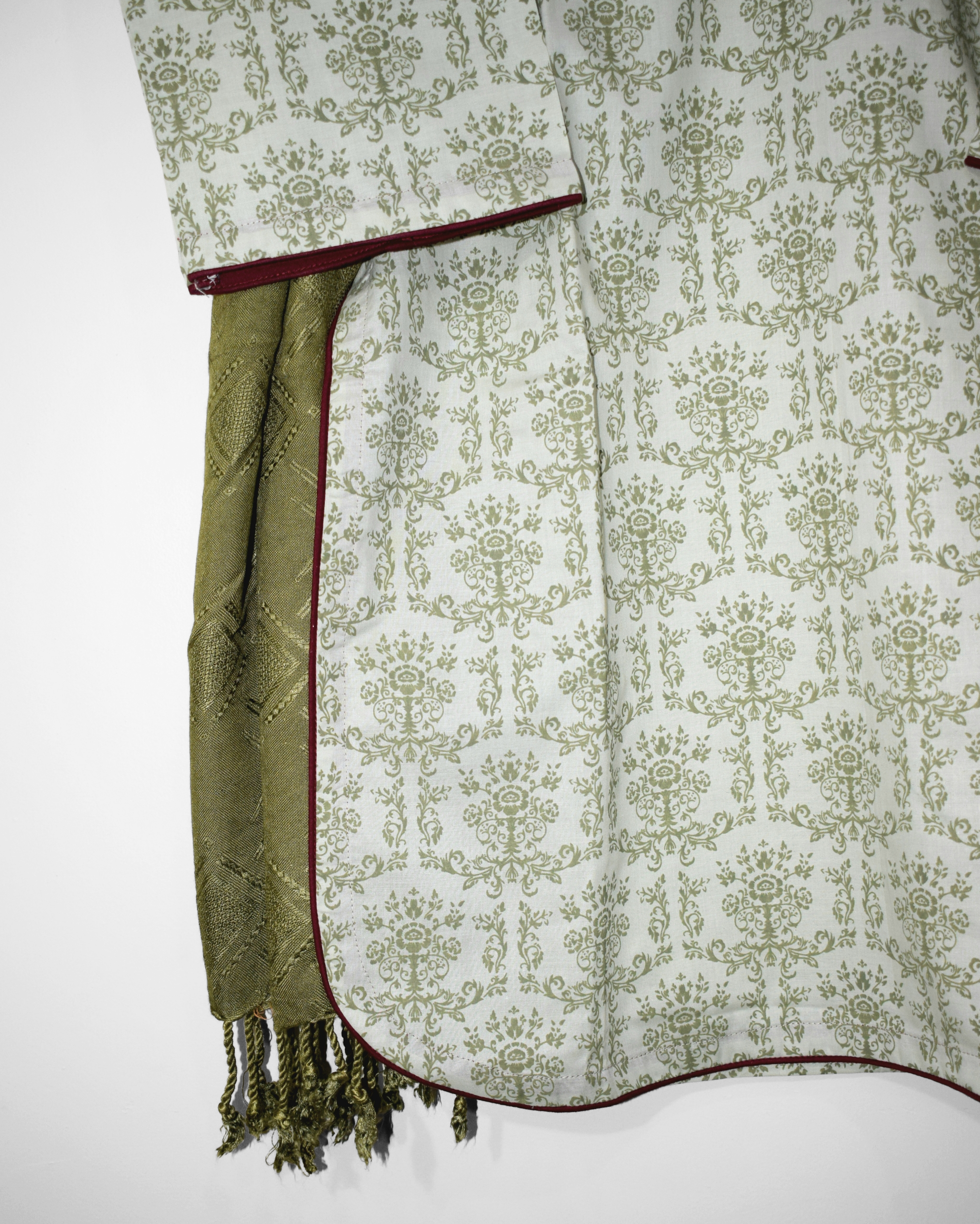 Daman detailing of Olive & Rose stitched suit — screen-printed green vine pattern on cotton fabric.