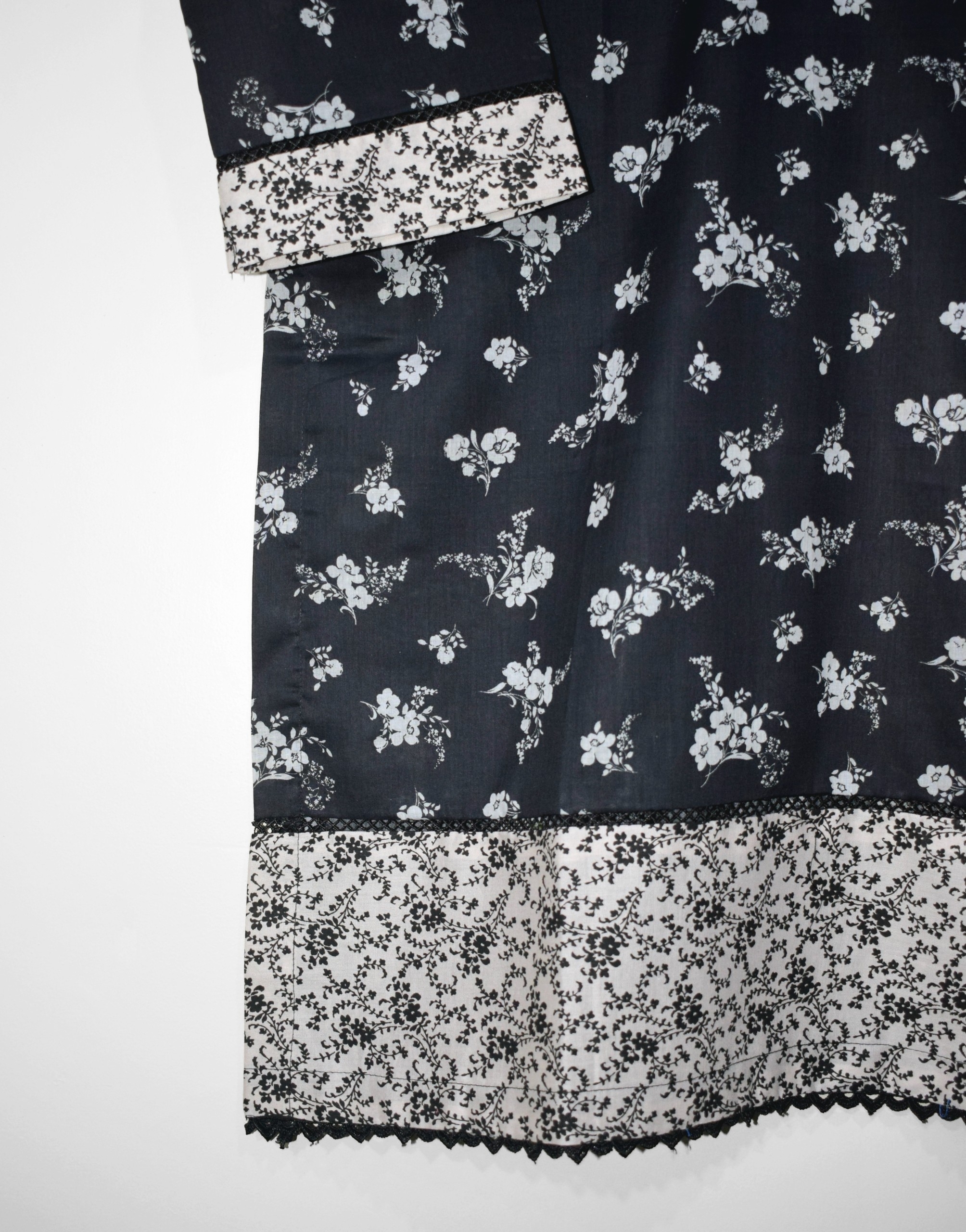 Printed daman design with floral white pattern on black lawn fabric, stitched finishing for summer outfit