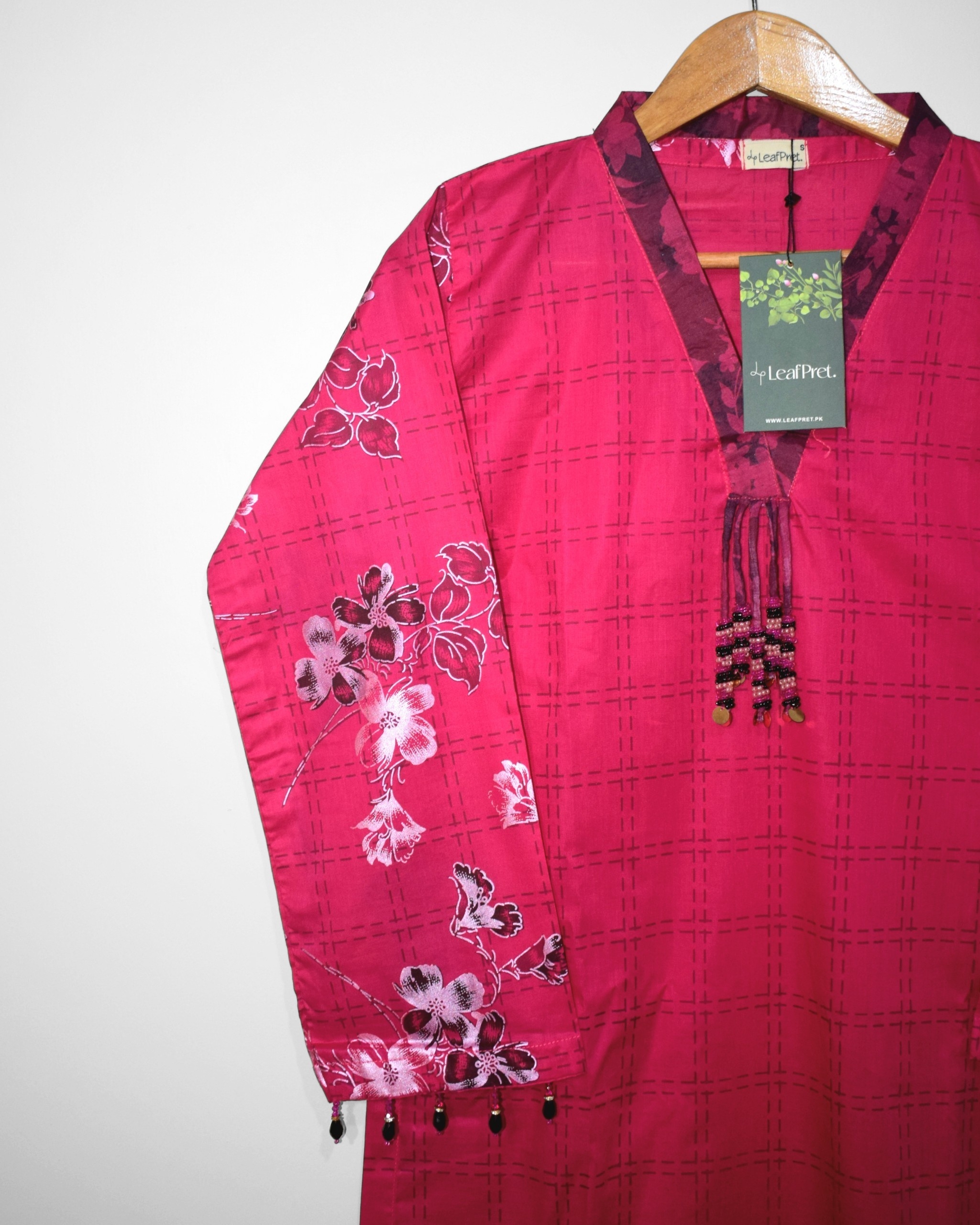 Closeup of Gulberry stitched lawn shirt featuring floral screen print, contrast neckline and tassel detailing by LeafPret