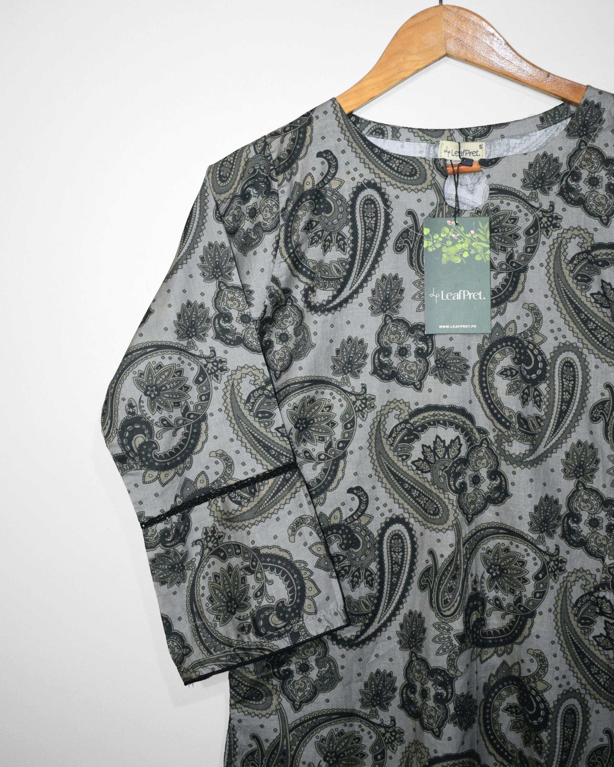 Closeup of Noir Paisley digital printed lawn shirt featuring black paisley motifs and elegant piping details