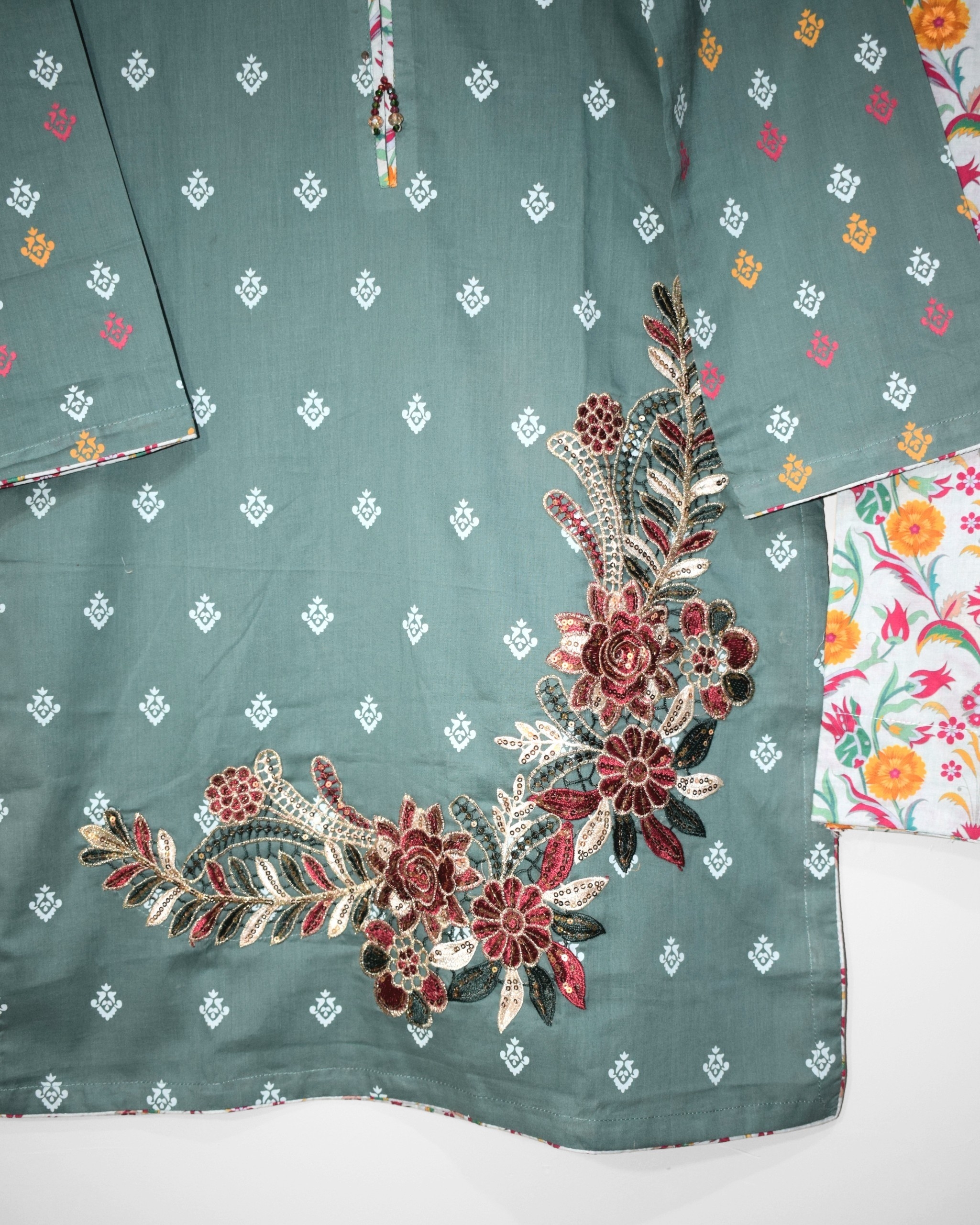 Embroidered floral daman patch detail on Sea Mist lawn shirt