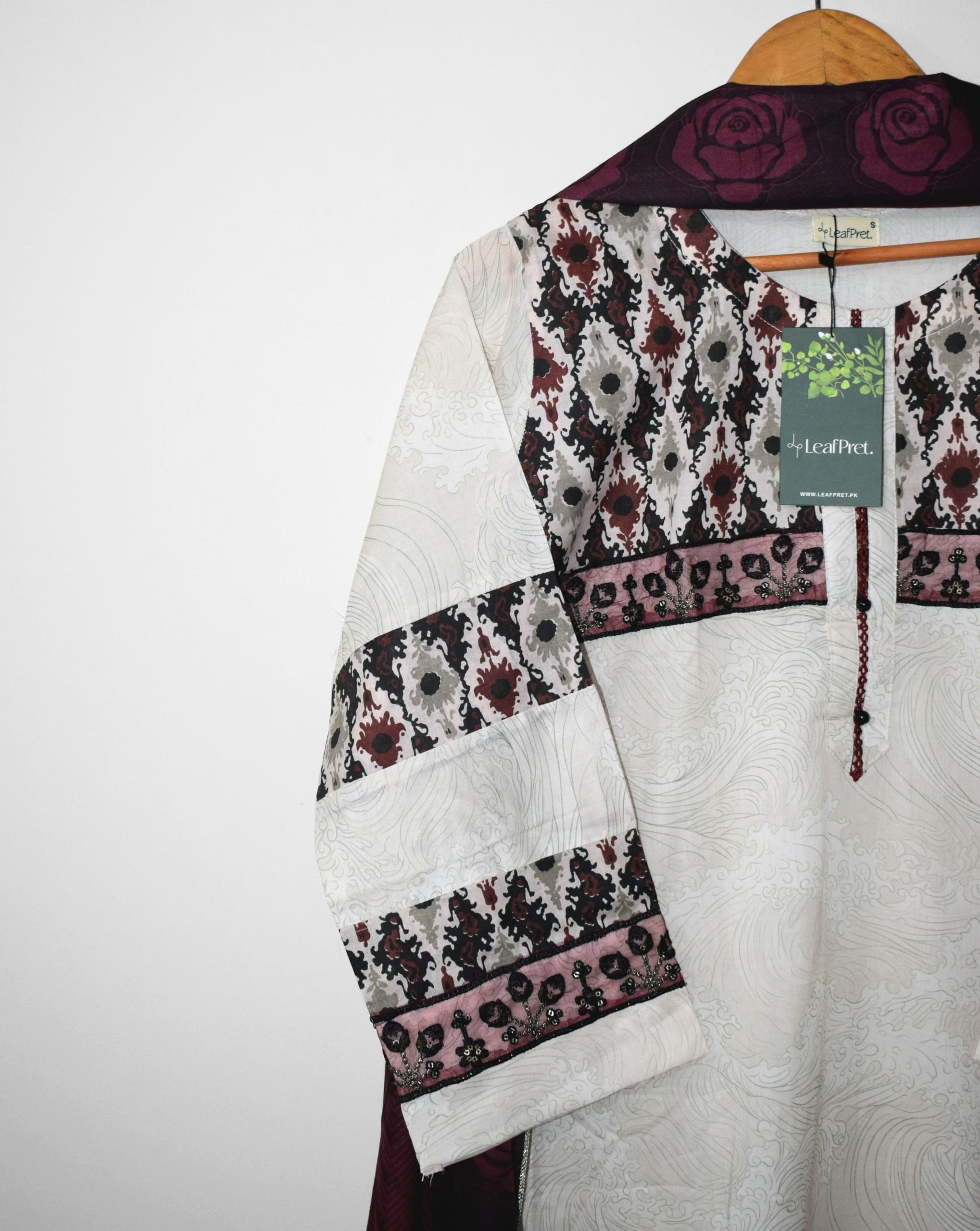 Close-up of Zaria lawn embroidery suit showcasing embroidered chest, sleeves and screen printed borders by LeafPret.